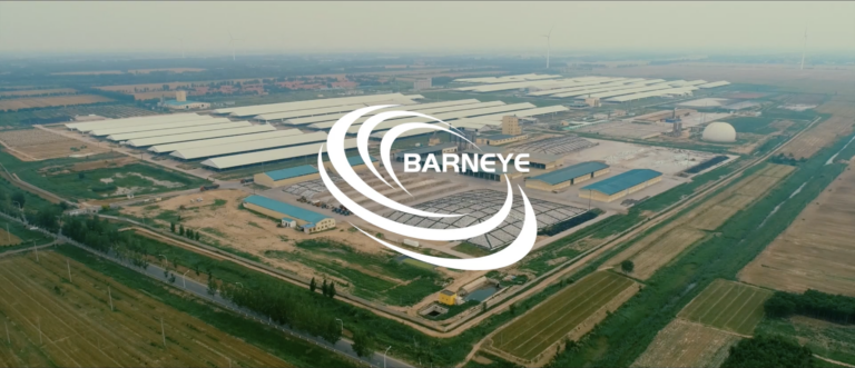 Aerial view of a large commercial dairy farm complex with many long barns and the BarnEye logo.